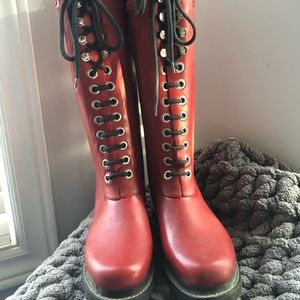 Red rubber lace-up boots by Ilse Jacobsen.